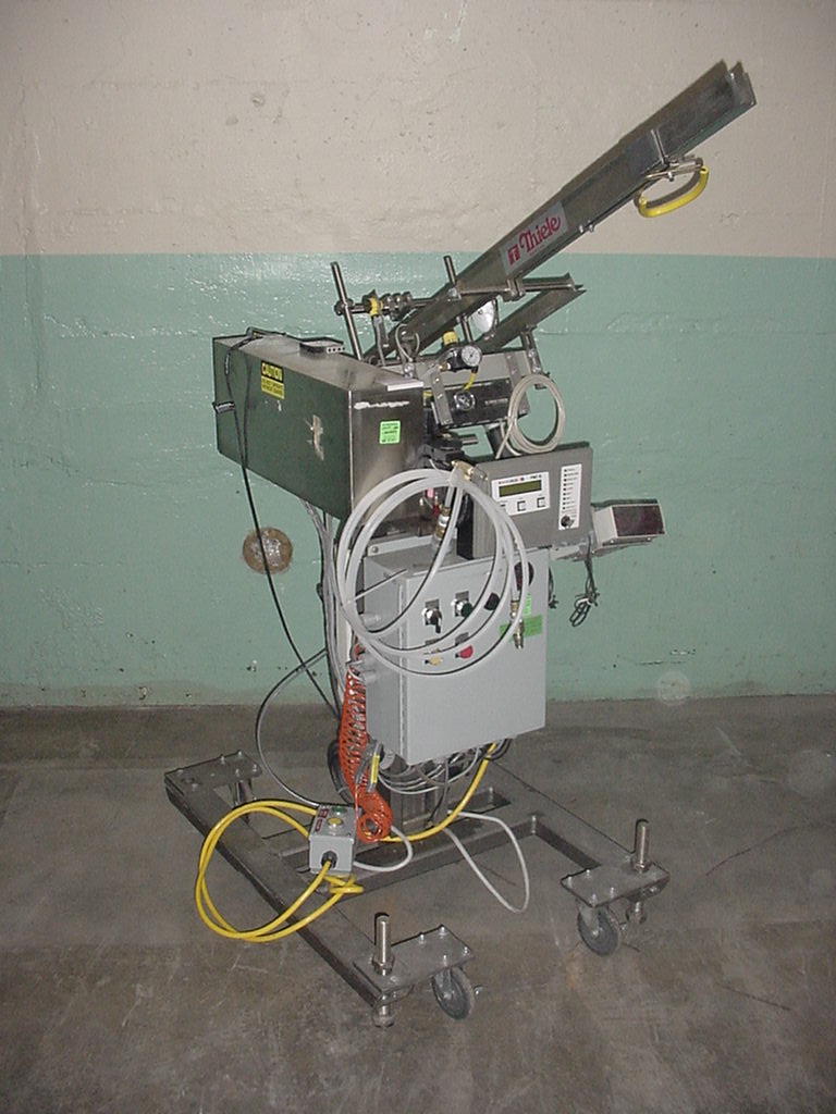 Labeler Thiele Engineering Co. reciprocating placer model S-106, up to 44 cpm1